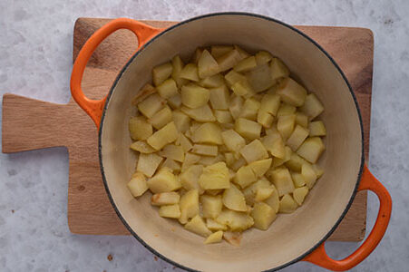 Die Apfelstücke werden in einem Topf gedünstet.