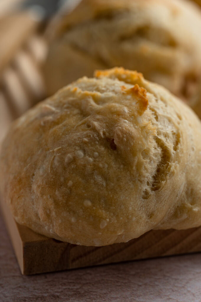 Ein Brötchen liegt auf einem Brett.