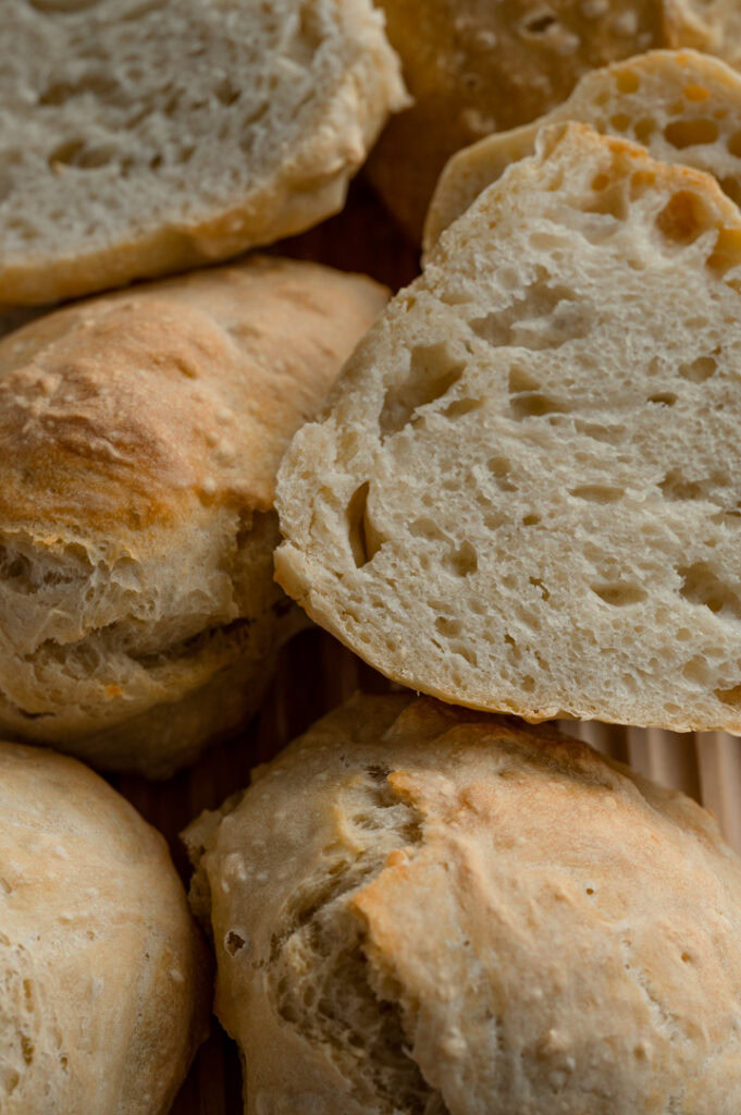 Die einfachen Brötchen ohne Formen liegen auf einem Brett.