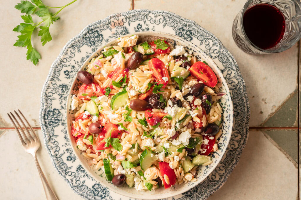 Eine große Schüssel mit griechischen Nudelsalat.