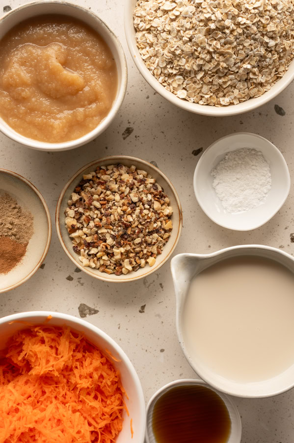 Die Zutaten für die Carrot Cake Baked Oats stehen auf einem Tisch.