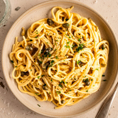 Ein Teller mit vegetarischer Spaghetti Carbonara ohne Tofu steht auf dem Tisch.