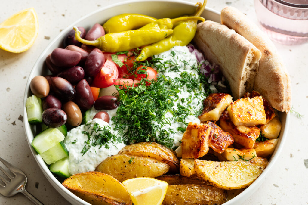 Ein Teller mit einer griechischen Bowl steht auf dem Tisch.